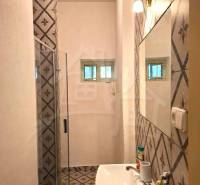 A bathroom with patterned tiles in a family house.