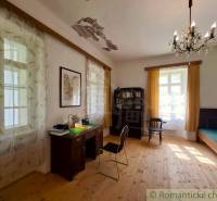 Interior of a family house with a desk, shelf, and floor with a wooden decor.
