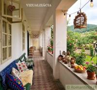 The veranda of a family house in Dobroč with decorations, cushions, and a view of the garden.