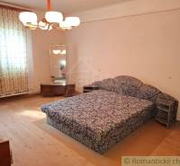 A room in a family house with carpet furniture and a mirror, wooden decor flooring.