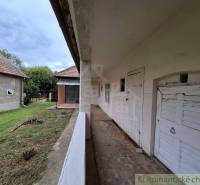 A family house in Mužla with a veranda and garden, country style and simple architecture.