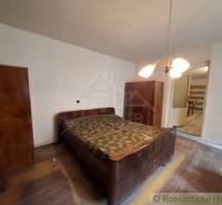 A bedroom in a family house with wooden cabinets and a wooden decor floor.
