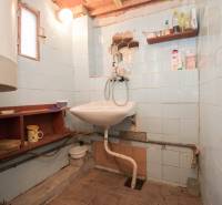 Bathroom with a sink, shelves, and light, suitable for recreational properties.