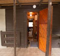 Entrance to the cabin with opening wooden doors and a porch on Recreational Land.