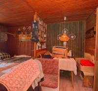 A rustic room on recreational grounds with wooden decor and comfortable seating.