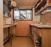 A small kitchen with shelves and old furniture on recreational grounds.
