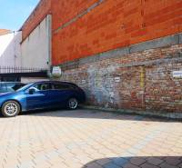 Parking lot near the brick building in the gastro premises of Trnava.