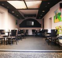 Interior of dining spaces with seating, decorations, and a houseplant.