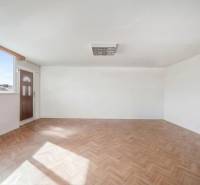 Spacious commercial premises with a large window and a wooden decor floor.