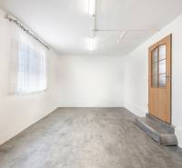 White walls, concrete floor, wooden door, and curtain in commercial premises.