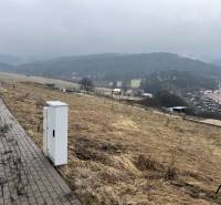 Residential plots in Stará Ľubovňa with a view of lush green hills.