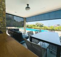 Terrace of the villa in Jakišnica with seating and a view of the pool.