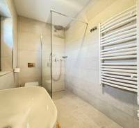 Bathroom in a villa with a shower and a white sink.