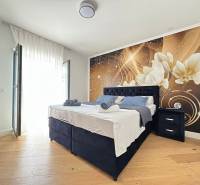 A bedroom in a villa with a decorative wall and a wooden decor floor.