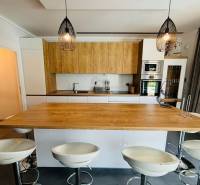 A kitchen in a villa with wooden decor and elegant lighting.