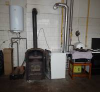 Gastro premises with a tiled stove and appliances, floor with wooden decor.