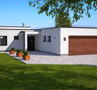 A family house in Dolná Seč with a white facade, a large terrace, and a green lawn.