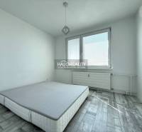 Bedroom with a gray floor featuring a wood design in a 2-room apartment.