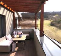 View from the terrace of a 2-room apartment in Podhájska on Svätuša, with comfortable seating.