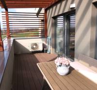 A 2-room apartment terrace with a view of the surroundings and floral decoration.