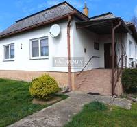 A family house in Hráň with a white facade, staircase, and garden.
