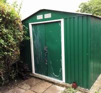 A garden at a family house in Bohdanovce nad Trnavou with a green metal garden shed.