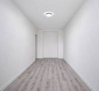 A narrow space with a wooden decor floor in a 3-room apartment.