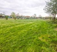 A green residential plot in Horná Kráľová surrounded by nature and trees.