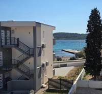 A view of the surroundings in Srima with a view of the sea and an apartment building.
