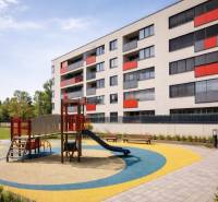 Malokrasňanská Street in Bratislava - Rača with an apartment building and a children's playground.