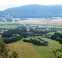 A view of agricultural and forest land in Dvorníky-Včeláre with an industrial area.