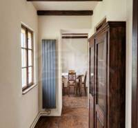 Wooden beams, wood-patterned floor, and an antique cabinet in a family house.