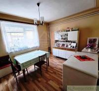 Dining room in a family house with a wooden decor floor and a dining table.