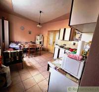 Kitchen in a family house with a dining table, chair, and kitchen appliances.