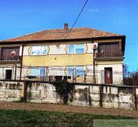 A family house in Kiarov with a brick fence and a satellite dish.
