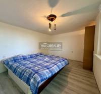 A peaceful bedroom with a simple bed and a wooden decor floor.
