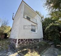 A family house surrounded by trees and shrubs in the gardens of the city of Rimavská Sobota.