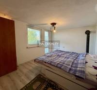 Bedroom with a wardrobe, bed, and floor with a wood decor in the interior of Gardens.