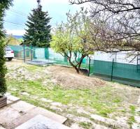 A family house in Bratislava-Záhorská Bystrica, Podkerepušky with a grassy yard and trees.