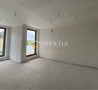 A spacious room with two large windows in a 2-room apartment.