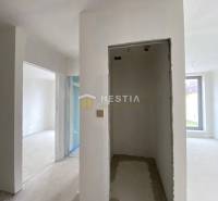 Interior of an unfinished 2-room apartment with plastered walls and a large window.