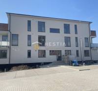 New building with balconies and parking, ideal investment for a 2-room apartment in a quiet location.