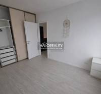 Interior of a 2-room apartment with a built-in wardrobe and flooring with a wood decor.