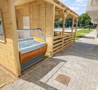 Wooden gastro spaces on Dukelská Street in Bernolákovo with an ice cream display.