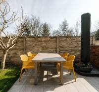 Terrace of a 4-room apartment on Cesta na Klanec in Lamač, with modern furniture and a tree.