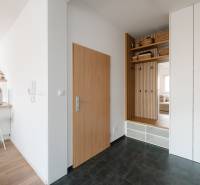 Entrance hallway with storage space, flooring with decor, and a kitchenette in a 4-room apartment.