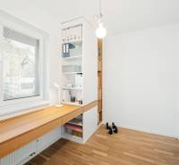 A study with a wooden desk and shelves in a 4-room apartment, floor with wooden decor.