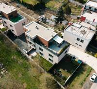 Aerial view of apartment roofs and gardens on Cesta na Klanec in Lamač.