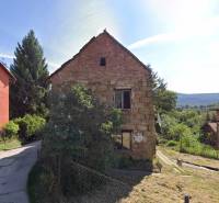 A family house on Ivana Krasko Street in Handlová with a brick facade and a garden.