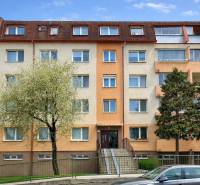 Apartment building on Latorická Street in Bratislava - Dolné hony with parking in the foreground.